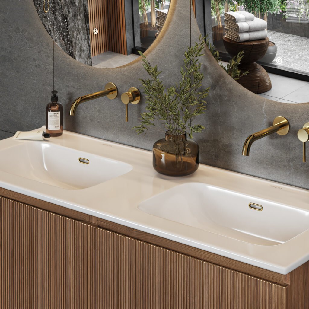 Double basin unit with fluted wood front, brass wall-mounted mixer taps and round wall mirrors.